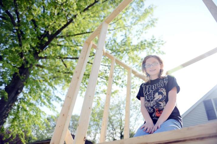 Samantha Carlson, of Selinsgrove, sits in a partially built tree house outside her home that her father began building for her as a gift for her 11th birthday. The Selinsgrove Zoning Hearing Board on Thursday night said the structure must come down.